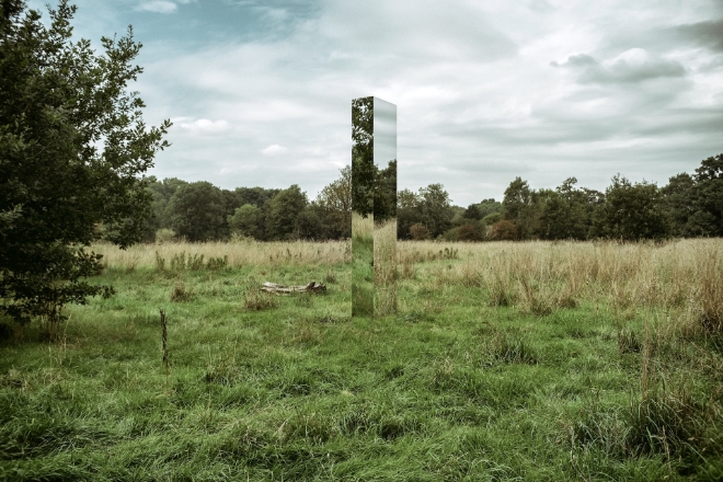 An opening in the woods, grass and trees, in the air gray and white clouds and a sliver of blue sky. In the middle of the field something unnatural: a monolith three meters tall made of reflecting glass. The reflections are confounding and disorienting. The monolith is a callback to the 1968 film by Stanley Kubric: "2001 a space odyssey" which uses a classical piece of music "Also sprach Zarathustra" to great dramatic effect . The monolith represents the const lambda function, the bane of my existence.